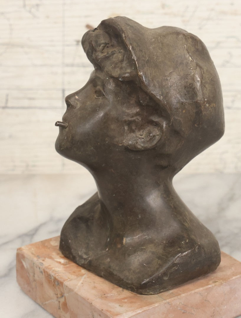 Lot 006 - Antique Spelter Bust Of Young Man With Tousled Hair, Cap, Smoking Cigarette Mounted On Marble Base, Hollow Form, Circa Early 20th Century, 7" H