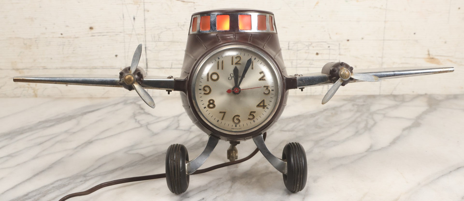 Lot 011 - Vintage Bakelite Airplane Form Clock With Internal Lamp, Note Clock Does Not Work And Both Propellers Missing One Blade