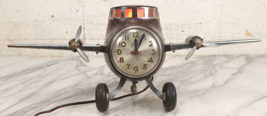 Lot 011 - Vintage Bakelite Airplane Form Clock With Internal Lamp, Note Clock Does Not Work And Both Propellers Missing One Blade