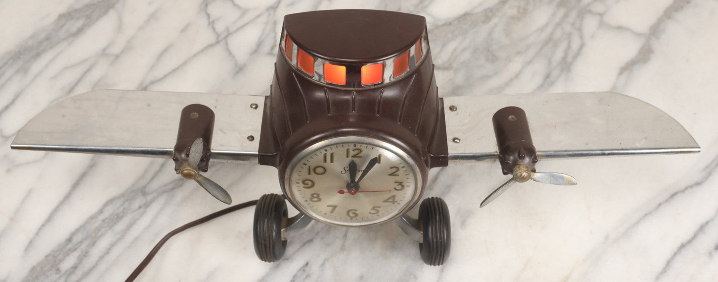 Lot 011 - Vintage Bakelite Airplane Form Clock With Internal Lamp, Note Clock Does Not Work And Both Propellers Missing One Blade