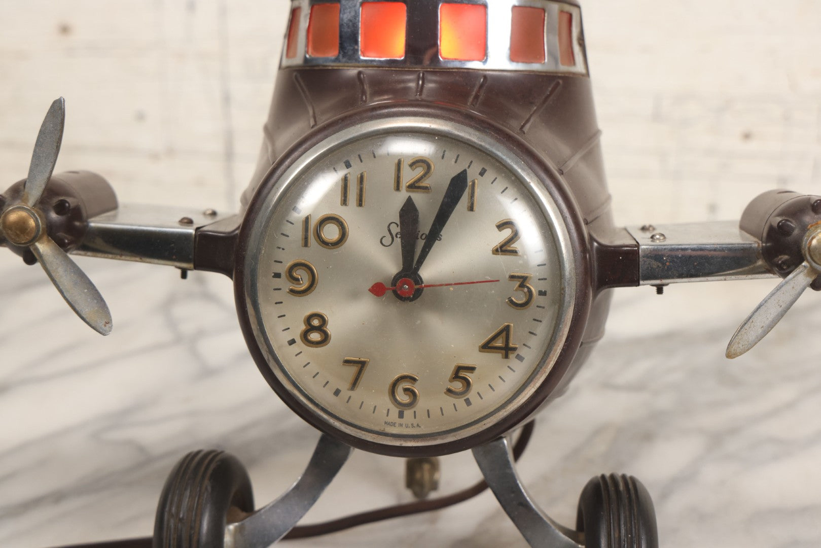 Lot 011 - Vintage Bakelite Airplane Form Clock With Internal Lamp, Note Clock Does Not Work And Both Propellers Missing One Blade