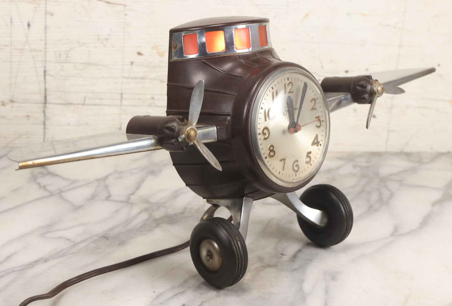 Lot 011 - Vintage Bakelite Airplane Form Clock With Internal Lamp, Note Clock Does Not Work And Both Propellers Missing One Blade