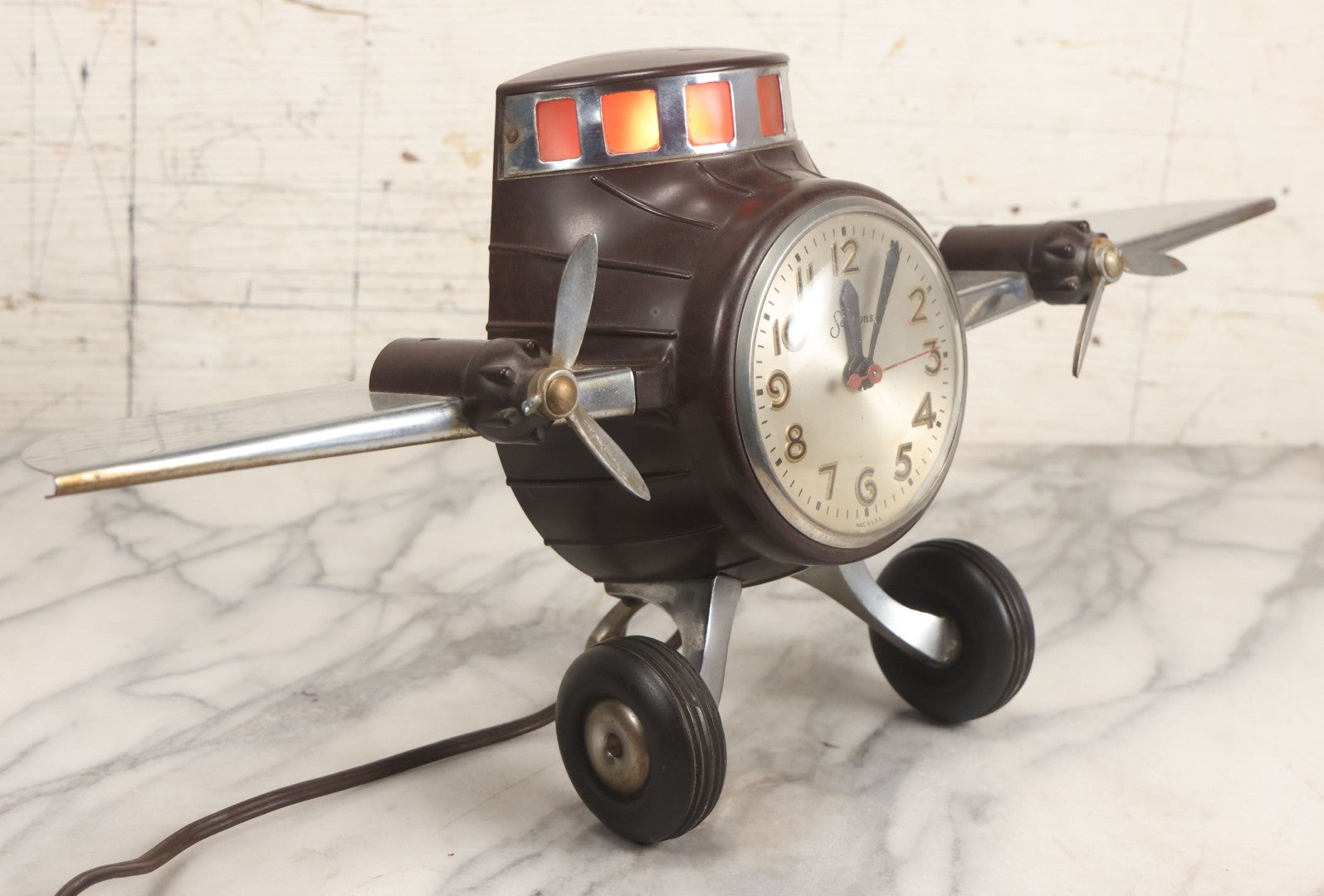 Lot 011 - Vintage Bakelite Airplane Form Clock With Internal Lamp, Note Clock Does Not Work And Both Propellers Missing One Blade
