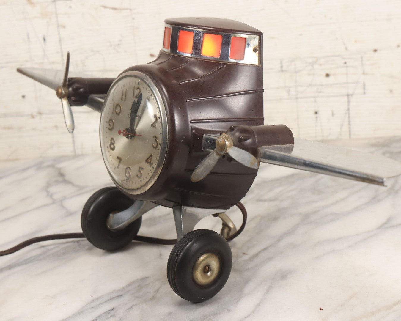 Lot 011 - Vintage Bakelite Airplane Form Clock With Internal Lamp, Note Clock Does Not Work And Both Propellers Missing One Blade