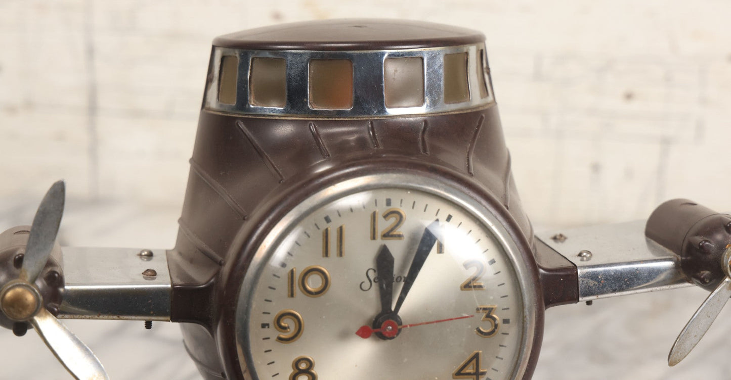 Lot 011 - Vintage Bakelite Airplane Form Clock With Internal Lamp, Note Clock Does Not Work And Both Propellers Missing One Blade