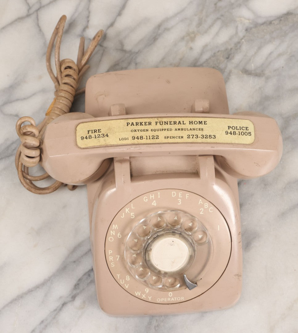 Lot 015 - Vintage Pink Rotary Telephone With Parker Funeral Home Label Advertising Oxygen Equipped Ambulances, Glow In The Dark Label With Numbers For Lodi, Spencer, Police And Fire, Untested