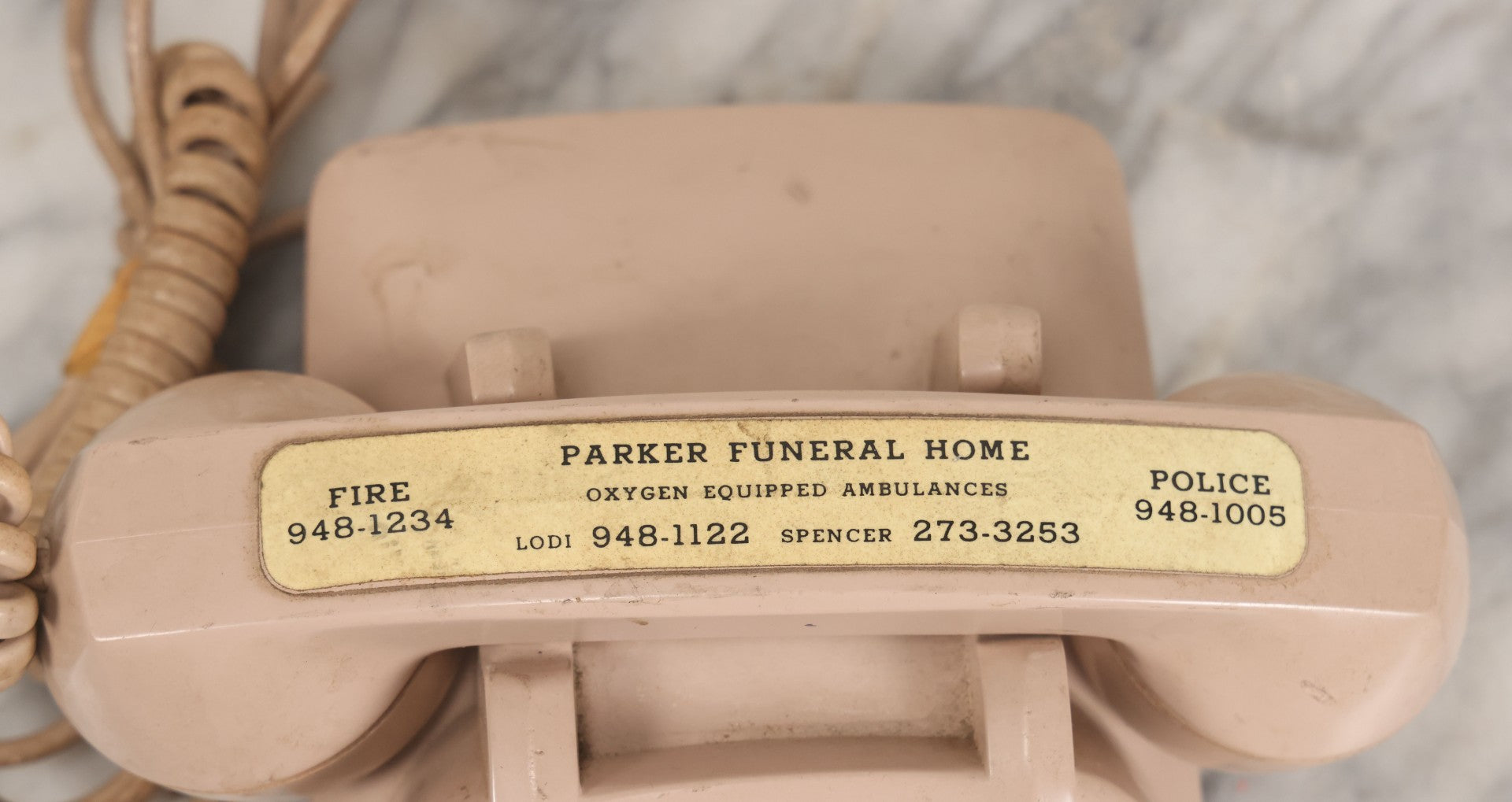 Lot 015 - Vintage Pink Rotary Telephone With Parker Funeral Home Label Advertising Oxygen Equipped Ambulances, Glow In The Dark Label With Numbers For Lodi, Spencer, Police And Fire, Untested