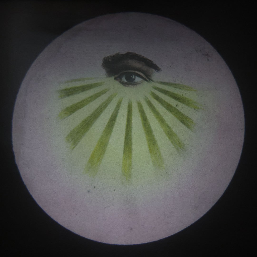 Lot 017 - Antique Hand Colored Odd Fellows I.O.O.F. Magic Lantern Glass Slide With Wood Holder, No. 1 All-Seeing Eye, Manufactured By The Henderson-Ames Co., Kalamazoo, Michigan