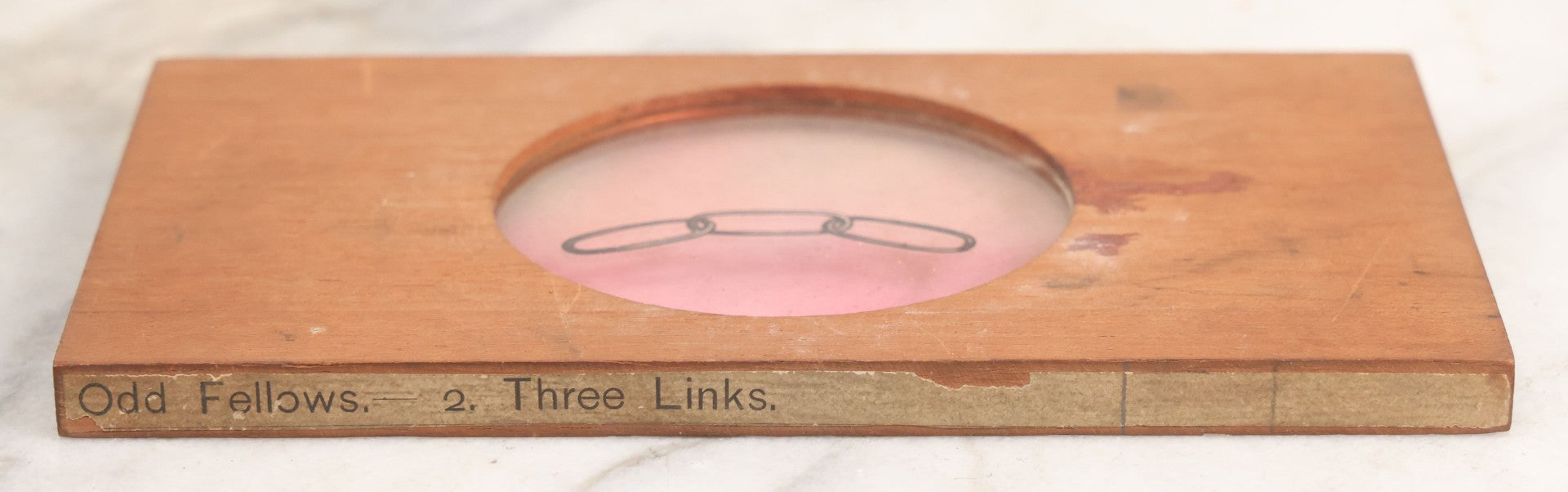 Lot 018 - Antique Hand Colored Odd Fellows I.O.O.F. Magic Lantern Glass Slide With Wood Holder, No. 2 Three Links, Manufactured By The Henderson-Ames Co., Kalamazoo, Michigan