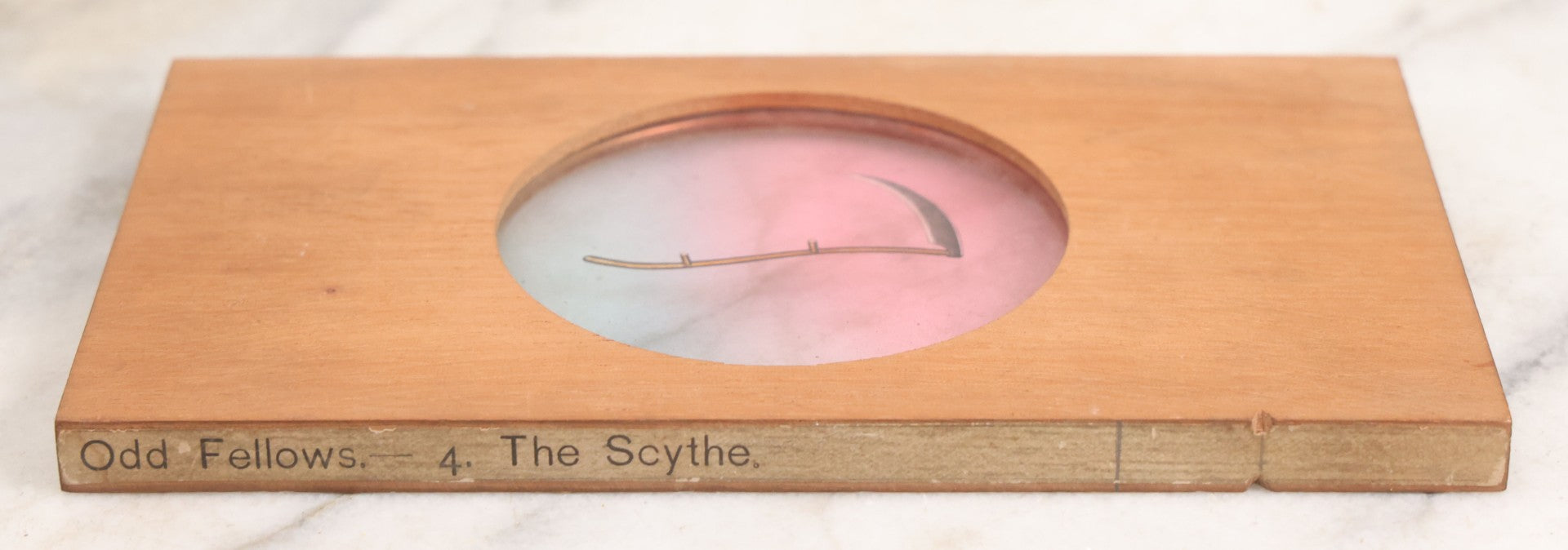 Lot 020 - Antique Hand Colored Odd Fellows I.O.O.F. Magic Lantern Glass Slide With Wood Holder, No. 4 The Scythe, Manufactured By The Henderson-Ames Co., Kalamazoo, Michigan