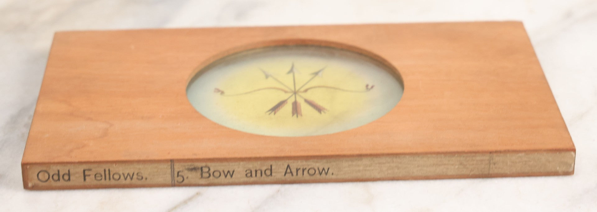 Lot 021 - Antique Hand Colored Odd Fellows I.O.O.F. Magic Lantern Glass Slide With Wood Holder, No. 5 Bow And Arrow, Manufactured By The Henderson-Ames Co., Kalamazoo, Michigan