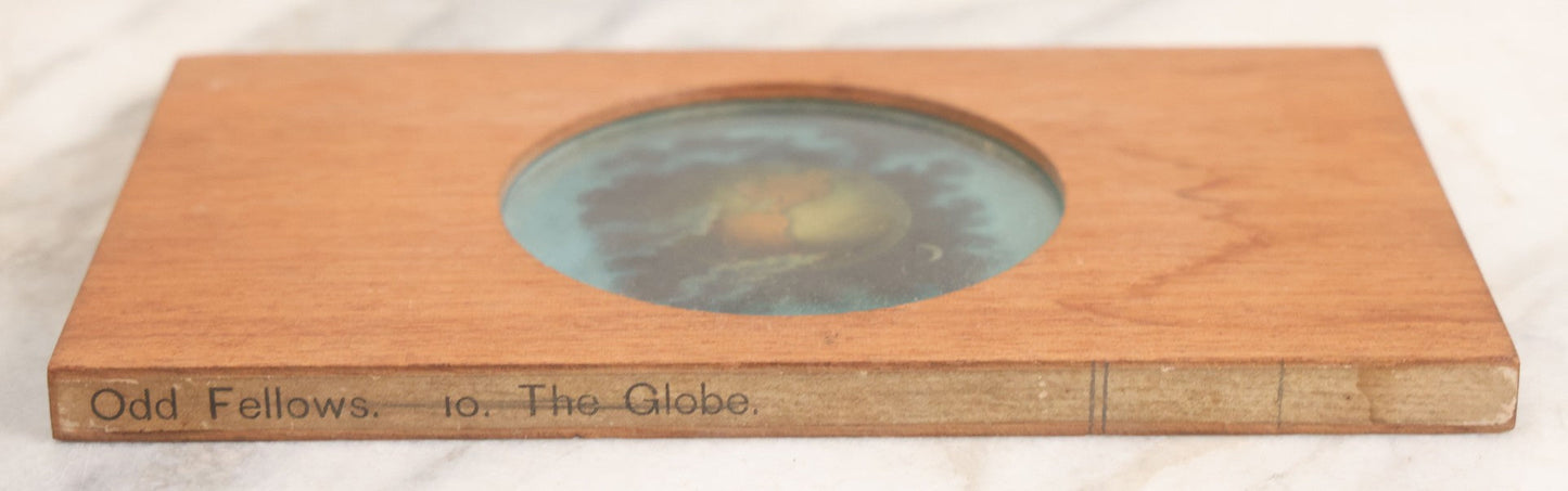 Lot 026 - Antique Hand Colored Odd Fellows I.O.O.F. Magic Lantern Glass Slide With Wood Holder, No. 10 The Globe, Manufactured By The Henderson-Ames Co., Kalamazoo, Michigan