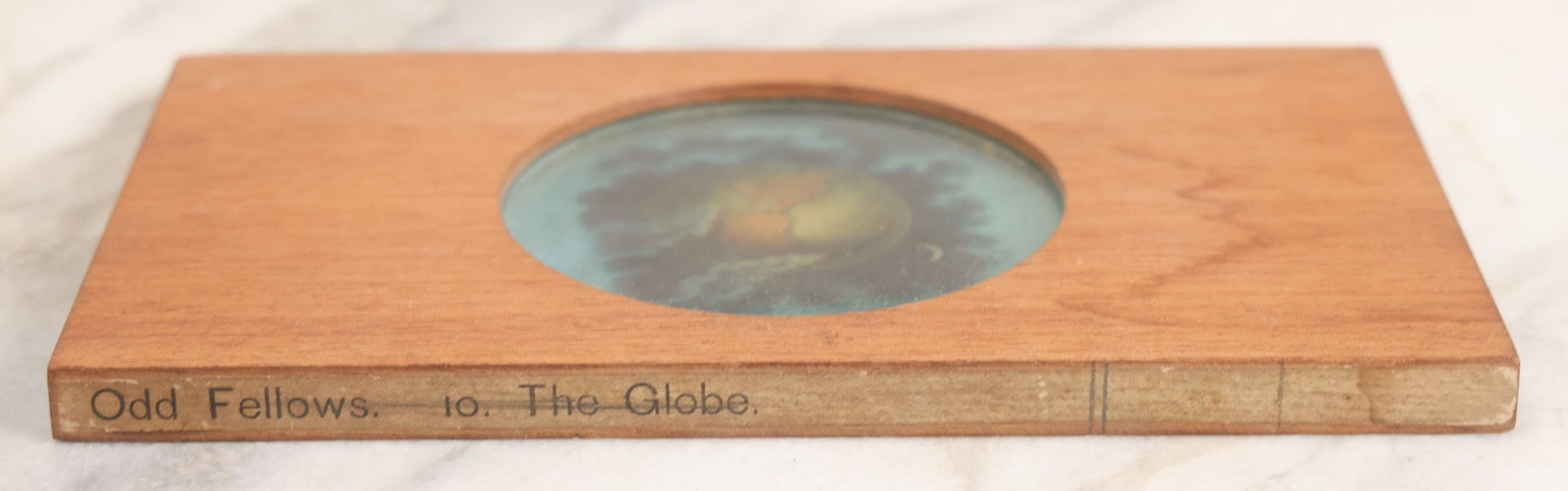 Lot 026 - Antique Hand Colored Odd Fellows I.O.O.F. Magic Lantern Glass Slide With Wood Holder, No. 10 The Globe, Manufactured By The Henderson-Ames Co., Kalamazoo, Michigan