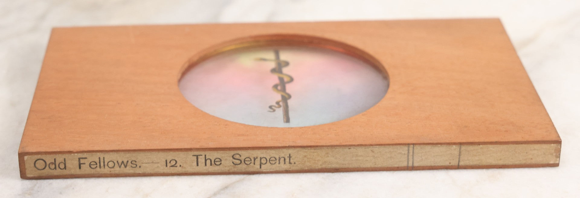 Lot 028 - Antique Hand Colored Odd Fellows I.O.O.F. Magic Lantern Glass Slide With Wood Holder, No. 12 The Serpent, Manufactured By The Henderson-Ames Co., Kalamazoo, Michigan