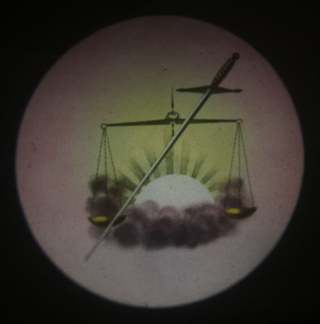 Lot 029 - Antique Hand Colored Odd Fellows I.O.O.F. Magic Lantern Glass Slide With Wood Holder, No. 13 Scales And Sword, Manufactured By The Henderson-Ames Co., Kalamazoo, Michigan