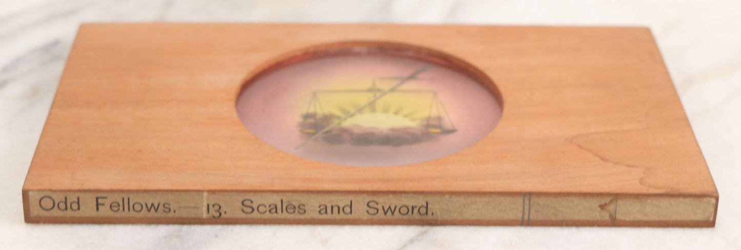Lot 029 - Antique Hand Colored Odd Fellows I.O.O.F. Magic Lantern Glass Slide With Wood Holder, No. 13 Scales And Sword, Manufactured By The Henderson-Ames Co., Kalamazoo, Michigan