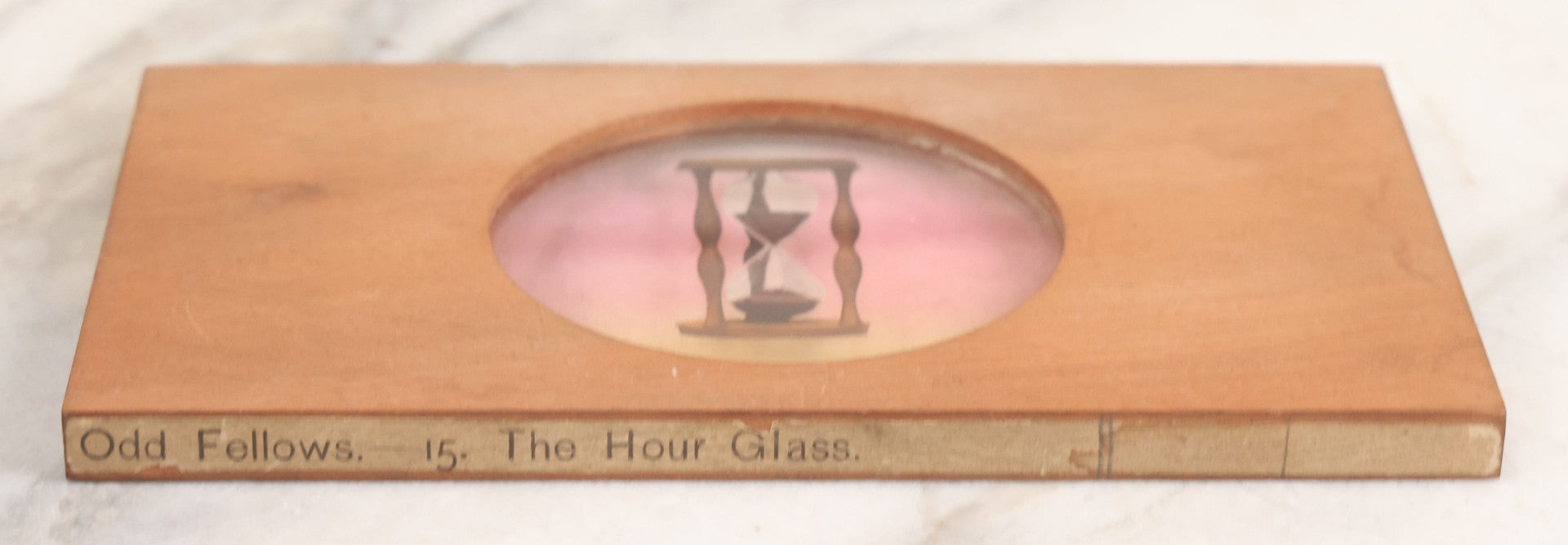 Lot 031 - Antique Hand Colored Odd Fellows I.O.O.F. Magic Lantern Glass Slide With Wood Holder, No. 15 The Hour Glass, Manufactured By The Henderson-Ames Co., Kalamazoo, Michigan