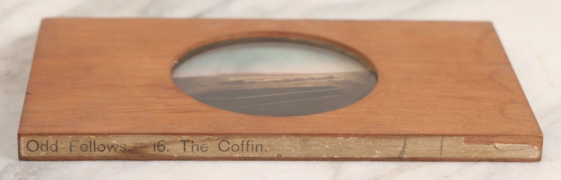 Lot 032 - Antique Hand Colored Odd Fellows I.O.O.F. Magic Lantern Glass Slide With Wood Holder, No. 16 The Coffin, Manufactured By The Henderson-Ames Co., Kalamazoo, Michigan