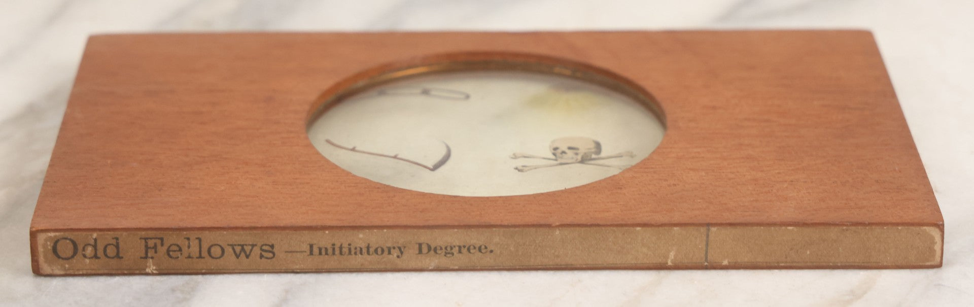 Lot 033 - Antique Hand Colored Odd Fellows I.O.O.F. Magic Lantern Glass Slide With Wood Holder, Initiatory Degree, Depicting The Three Links, Scythe, Skull And Cross-Bones, And All-Seeing Eye, Manufactured By The Henderson-Ames Co., Kalamazoo, Michigan