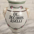 Lot 075 - Vintage Handarbeit Apothecary Pharmacy Lidded Jar Fantasy Reproduction "Ol. Jecoris Aselli" (Cod Liver Oil) With Craquelure Finish, Hand-Painted Roses, Figural Raised Heads On Sides, Unmarked, 7-1/4" H