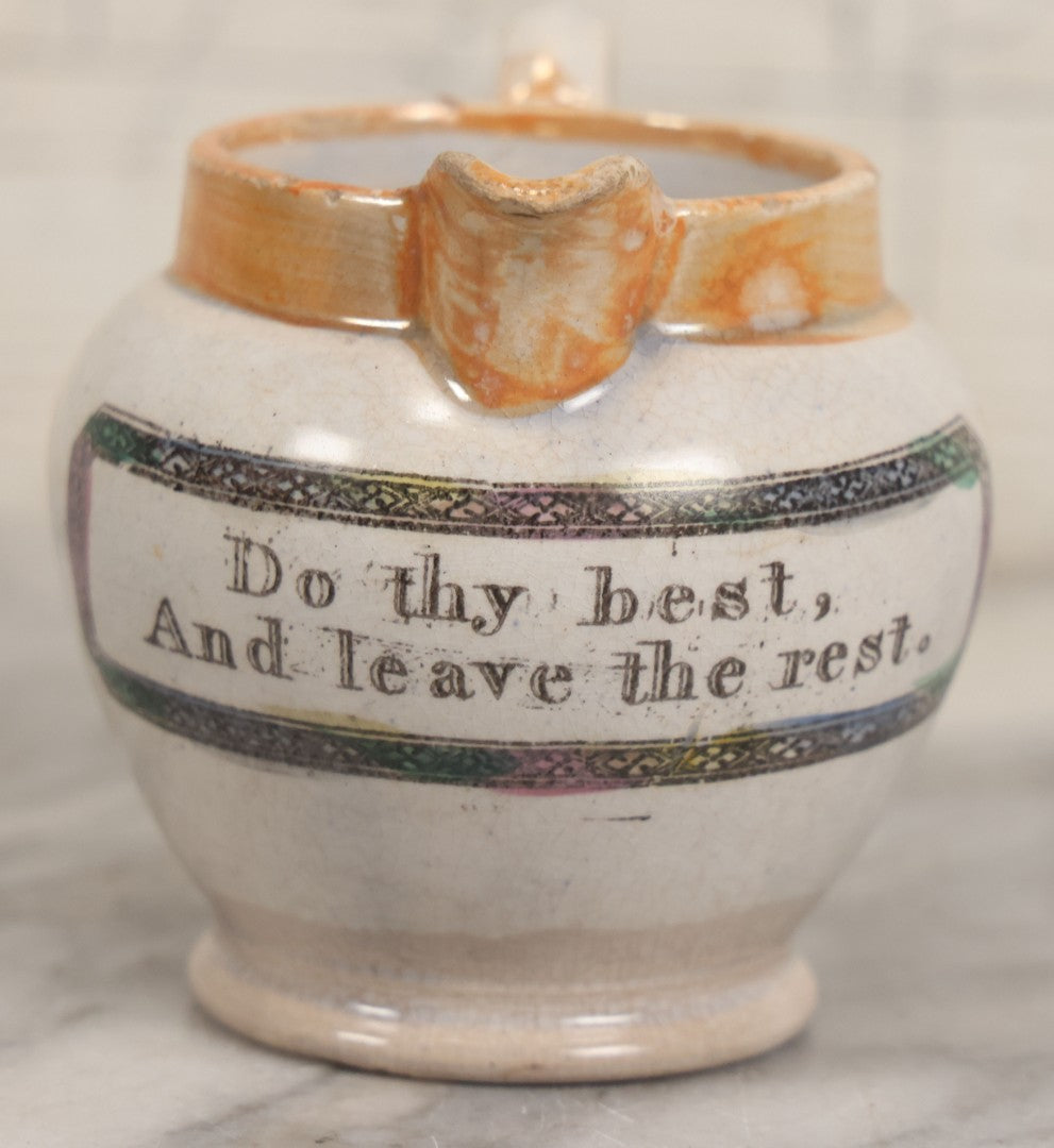 Lot 076 - Antique Hand Colored Transferware Creamer With "Do Thy Best, And Leave The Rest." Motto, Metallic Orange Paint On Sides, Handle And Rim, Unmarked, 3-3/8" H