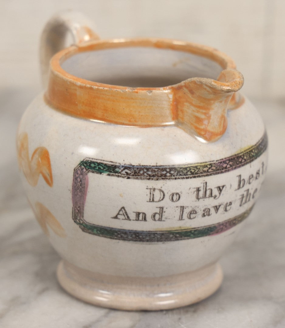 Lot 076 - Antique Hand Colored Transferware Creamer With "Do Thy Best, And Leave The Rest." Motto, Metallic Orange Paint On Sides, Handle And Rim, Unmarked, 3-3/8" H