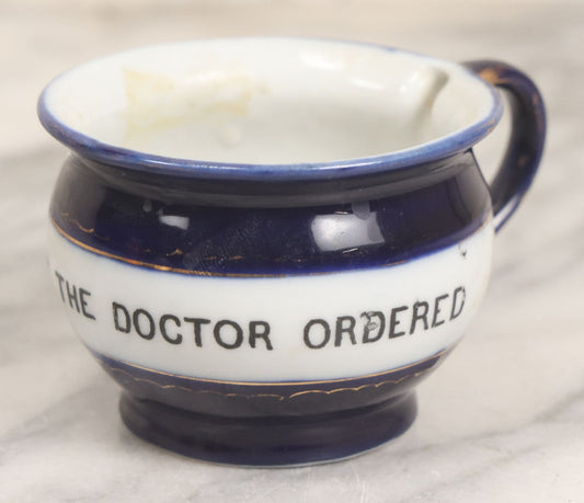 Lot 077 - Vintage Ceramic Cup, Deep Blue Glaze With Gold Lines, Transferware Text "Just What The Doctor Ordered," Marked Made In Germany, 2-1/8" H