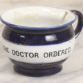 Lot 077 - Vintage Ceramic Cup, Deep Blue Glaze With Gold Lines, Transferware Text "Just What The Doctor Ordered," Marked Made In Germany, 2-1/8" H