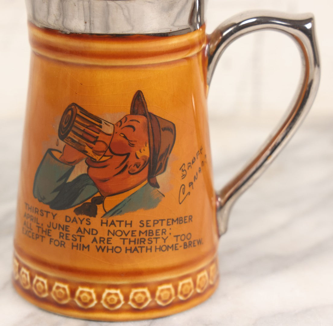 Lot 079 - Vintage Pottery Stein With "Home-Brew" Verse With Beer Chugging Man And "What's Yours?" Illustration On Verso, Metallic Painted Lip And Handle, Stamped Makers Mark Lord Nelson Pottery, England On Bottom, 5-1/4" H