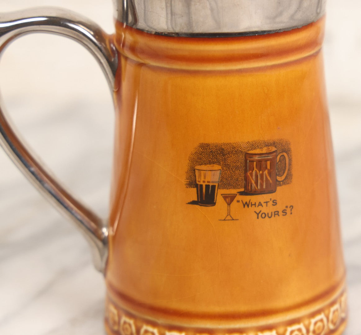 Lot 079 - Vintage Pottery Stein With "Home-Brew" Verse With Beer Chugging Man And "What's Yours?" Illustration On Verso, Metallic Painted Lip And Handle, Stamped Makers Mark Lord Nelson Pottery, England On Bottom, 5-1/4" H