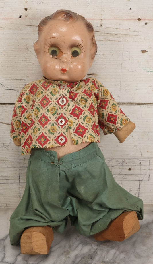 Lot 086 - Vintage Composition Head Googly Eye Baby Doll With Wooden Feet And Cloth Body, Wearing Patterned Shirt And Green Pants, 15-1/2" H
