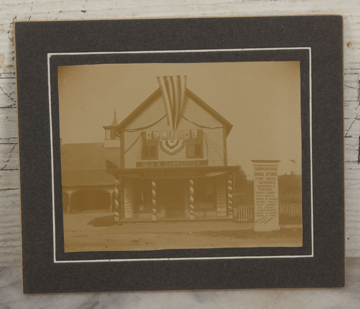 Lot 116 - Antique Boarded Photograph Of George W. Carpenter's Drug Store Apothecary, Likely Keene, New Hampshire, Decorated With Flags And Patriotic Bunting