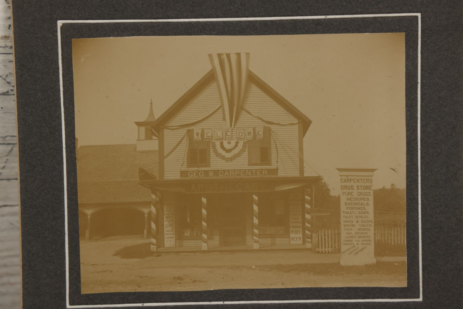 Lot 116 - Antique Boarded Photograph Of George W. Carpenter's Drug Store Apothecary, Likely Keene, New Hampshire, Decorated With Flags And Patriotic Bunting