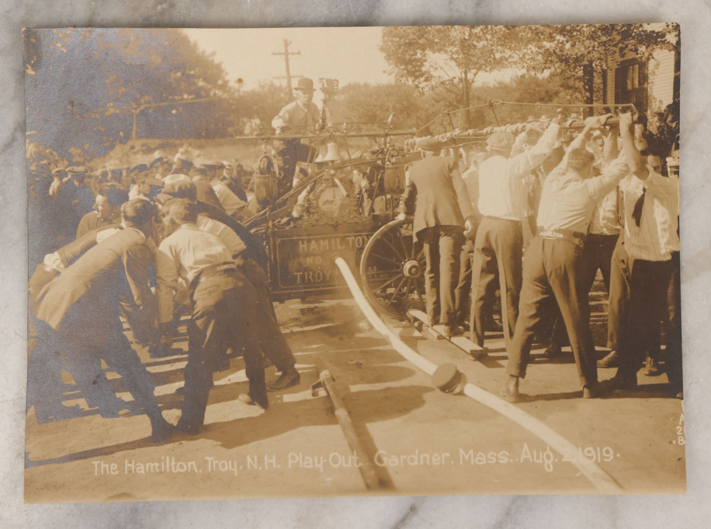Lot 135 - Antique Photograph Of Hamilton Fire Company, Troy, New Hampshire, At “Play-Out” Event, Gardner, Massachusetts, August 2, 1919