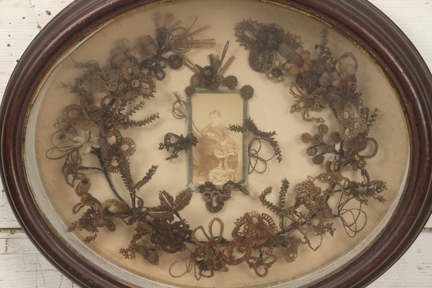 Lot 001 - Antique Victorian Mourning Memorial Human Hair Work Wreath In Deep Oval Shadowbox With Carte De Visite CDV Photograph Of Young Child In Blue Velvet Surround, 18-1/8" x 15-1/4"