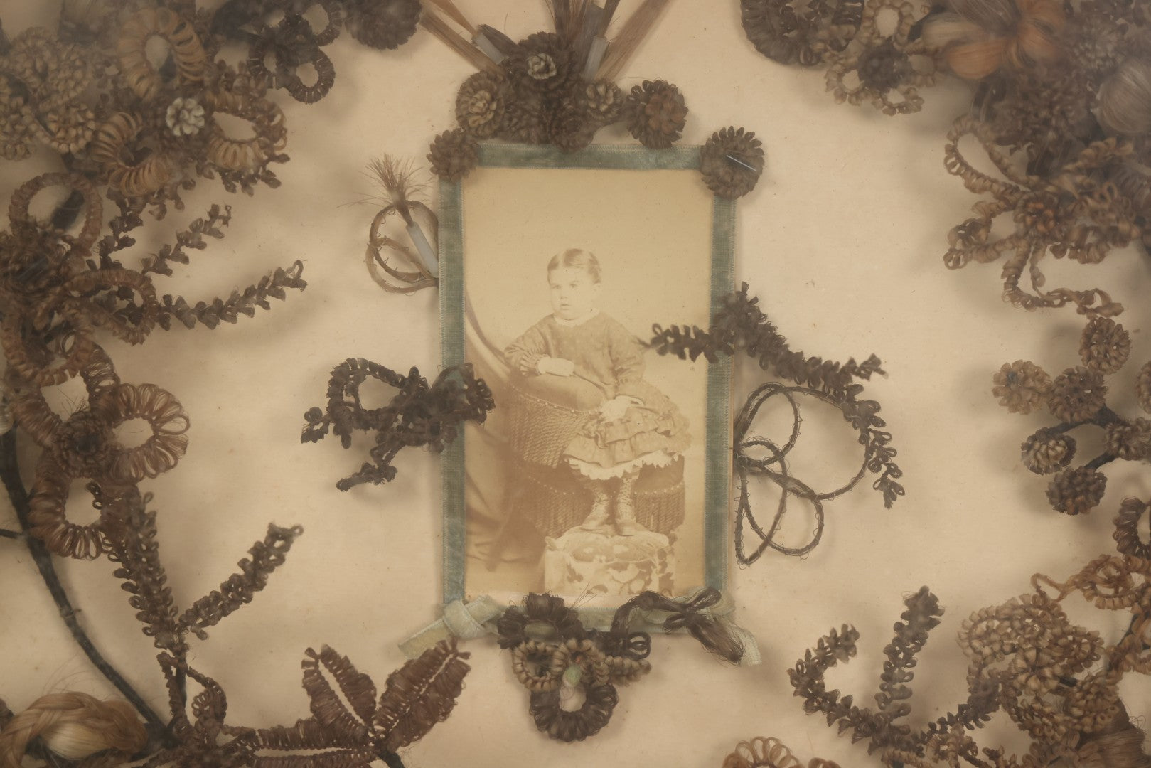 Lot 001 - Antique Victorian Mourning Memorial Human Hair Work Wreath In Deep Oval Shadowbox With Carte De Visite CDV Photograph Of Young Child In Blue Velvet Surround, 18-1/8" x 15-1/4"