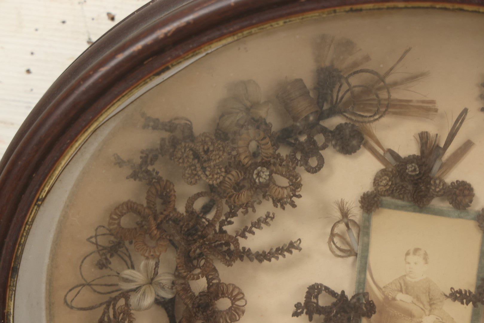 Lot 001 - Antique Victorian Mourning Memorial Human Hair Work Wreath In Deep Oval Shadowbox With Carte De Visite CDV Photograph Of Young Child In Blue Velvet Surround, 18-1/8" x 15-1/4"