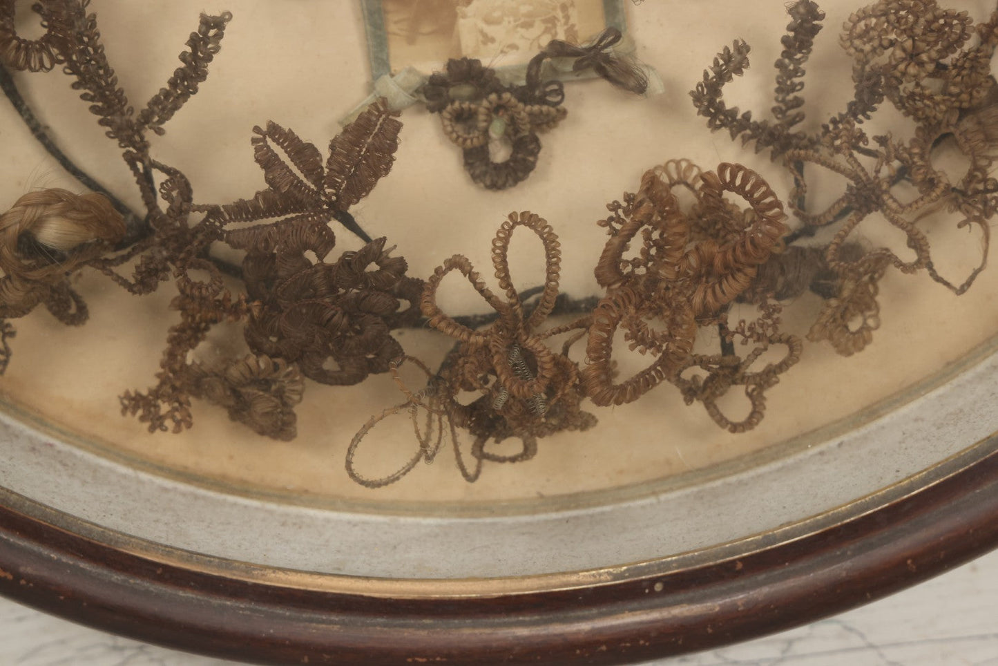 Lot 001 - Antique Victorian Mourning Memorial Human Hair Work Wreath In Deep Oval Shadowbox With Carte De Visite CDV Photograph Of Young Child In Blue Velvet Surround, 18-1/8" x 15-1/4"