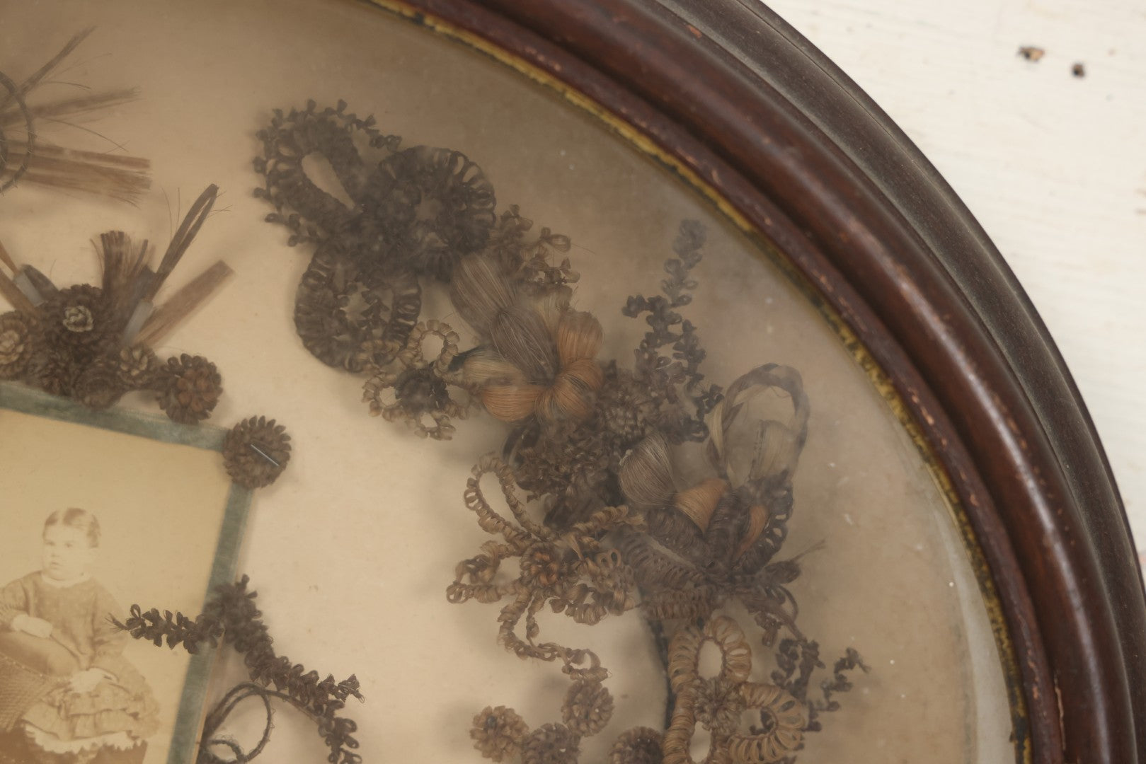 Lot 001 - Antique Victorian Mourning Memorial Human Hair Work Wreath In Deep Oval Shadowbox With Carte De Visite CDV Photograph Of Young Child In Blue Velvet Surround, 18-1/8" x 15-1/4"