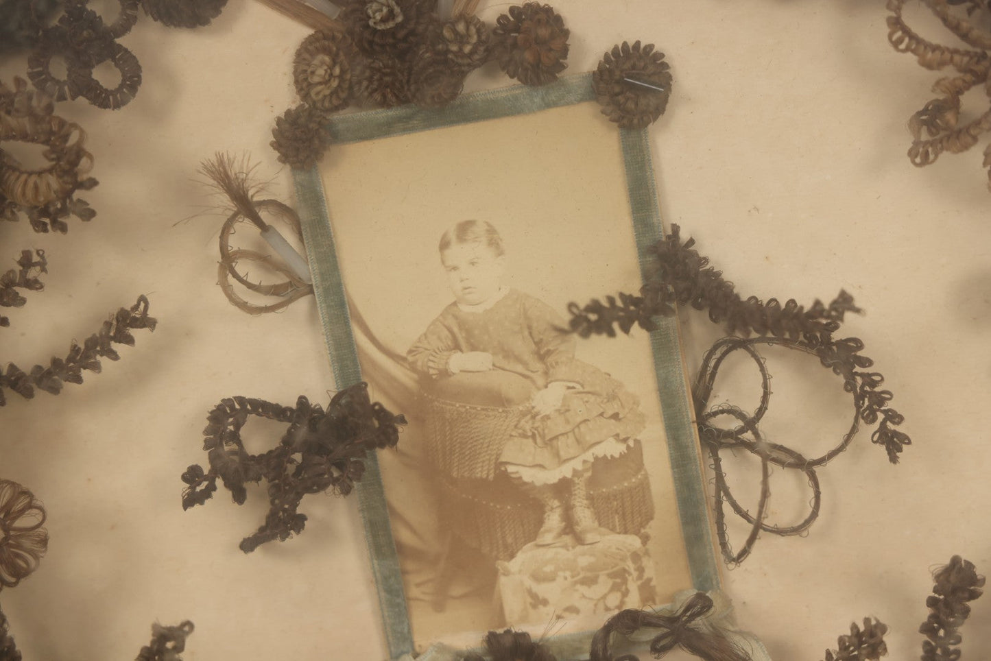 Lot 001 - Antique Victorian Mourning Memorial Human Hair Work Wreath In Deep Oval Shadowbox With Carte De Visite CDV Photograph Of Young Child In Blue Velvet Surround, 18-1/8" x 15-1/4"