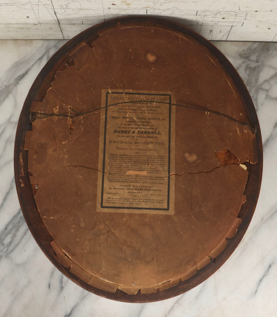 Lot 002 - Antique Victorian Mourning Memorial Preserved Flower Wreath "In Memory Of Our Darling George" In Original Deep Oval Shadowbox With Carte De Visite CDV Photograph And Hardy & Yarnall, Philadelphia Label, 17" x 20"