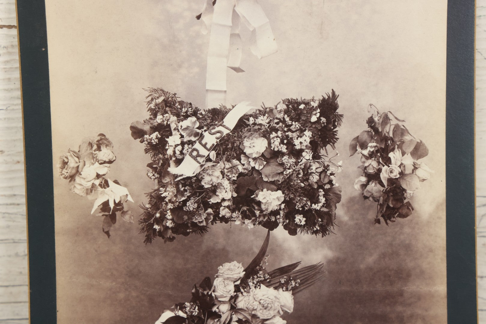 Lot 006 - Antique Boarded Mourning Photograph Depicting “Rest” Floral Pillow And Funeral Arrangements, 6-7/8" x 9-5/8"