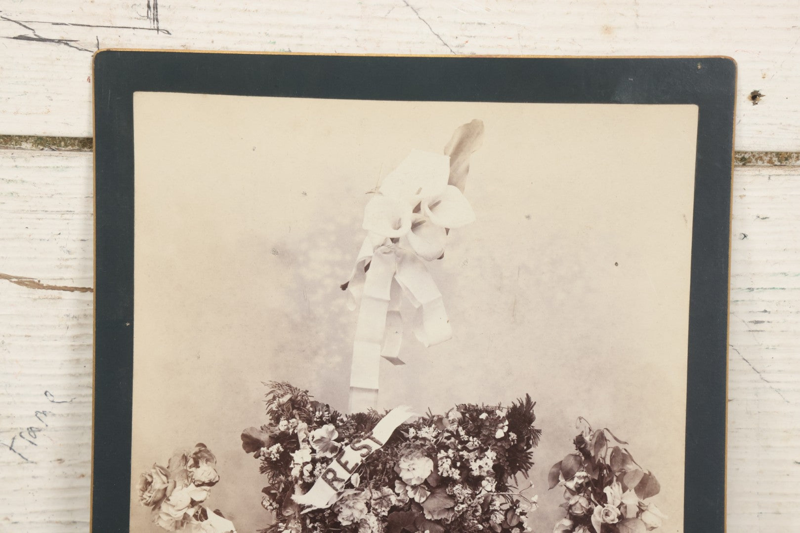 Lot 006 - Antique Boarded Mourning Photograph Depicting “Rest” Floral Pillow And Funeral Arrangements, 6-7/8" x 9-5/8"