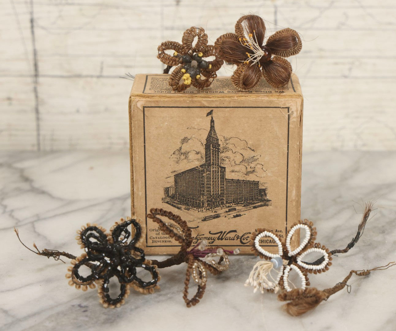 Lot 008 - Grouping Of Five Antique Victorian Human Hair Work Flowers With Beadwork Plus Fragment In Montgomery Ward & Co. Chicago Paper Box