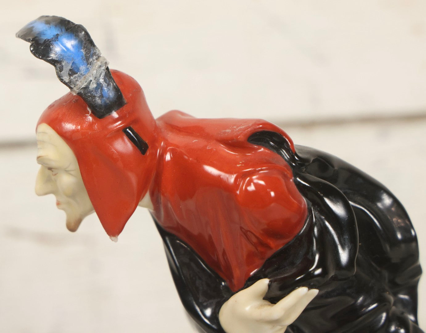 Lot 012 - Vintage Porcelain Mephisto (Mephistopheles) Figurine, By Karl Tutter For Hutschenreuther, Germany, Kunstabteilung, U.S. Zone Mark, Note Feather-On-Hat And Hood Repaired With Visible Glue, Circa 1955, 11-1/2" H