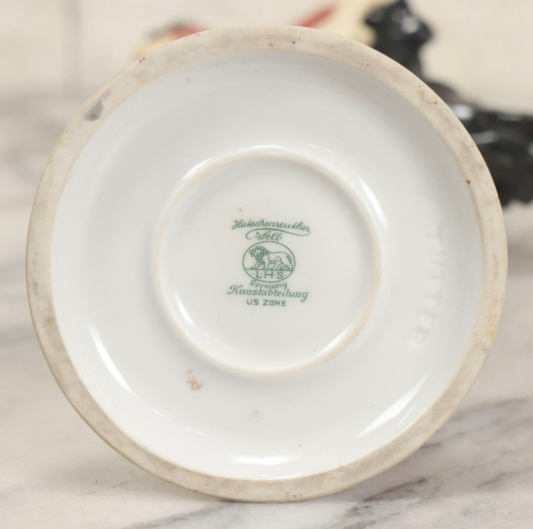 Lot 012 - Vintage Porcelain Mephisto (Mephistopheles) Figurine, By Karl Tutter For Hutschenreuther, Germany, Kunstabteilung, U.S. Zone Mark, Note Feather-On-Hat And Hood Repaired With Visible Glue, Circa 1955, 11-1/2" H