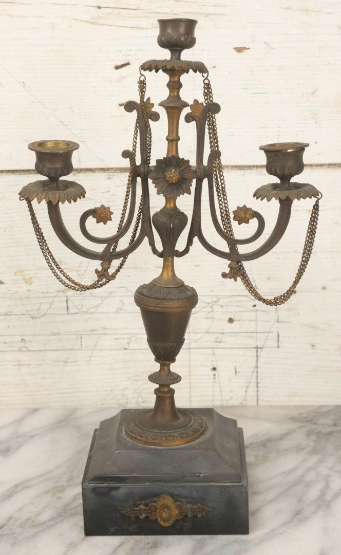Lot 018 - Pair Of Antique Brass Three-Arm Candelabras With Floral Rosettes, Chains, And Ornate Ornamentation On Black Slate Bases, Circa 1850, 13-1/2" H Each