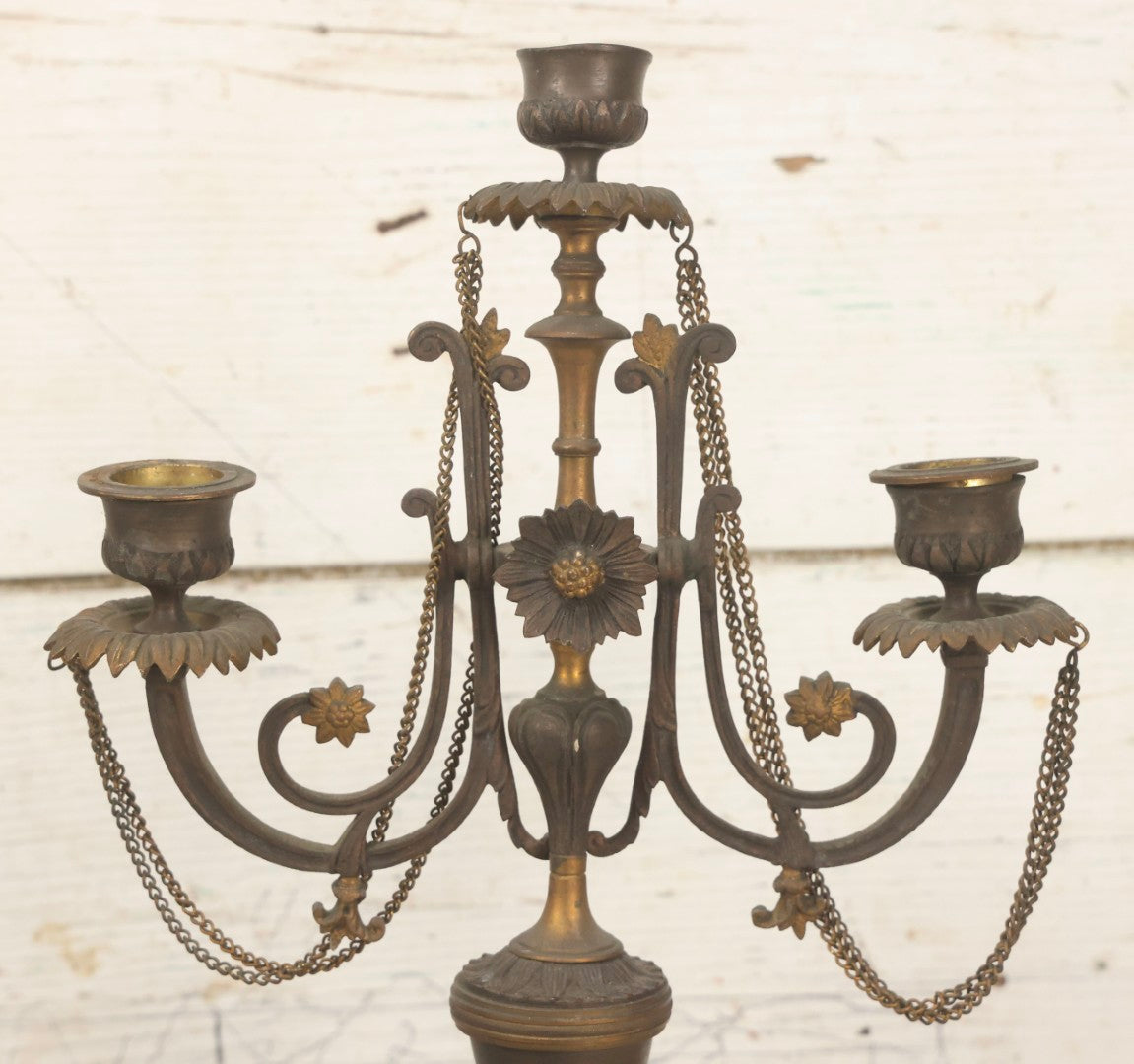 Lot 018 - Pair Of Antique Brass Three-Arm Candelabras With Floral Rosettes, Chains, And Ornate Ornamentation On Black Slate Bases, Circa 1850, 13-1/2" H Each