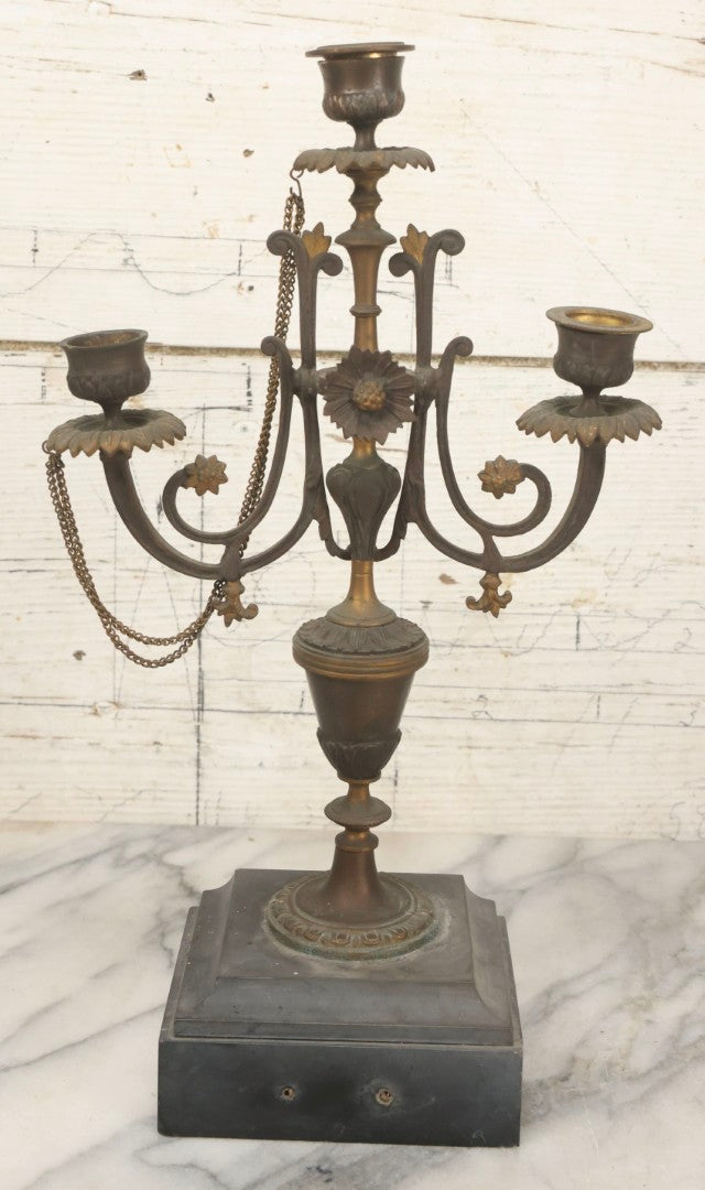 Lot 018 - Pair Of Antique Brass Three-Arm Candelabras With Floral Rosettes, Chains, And Ornate Ornamentation On Black Slate Bases, Circa 1850, 13-1/2" H Each