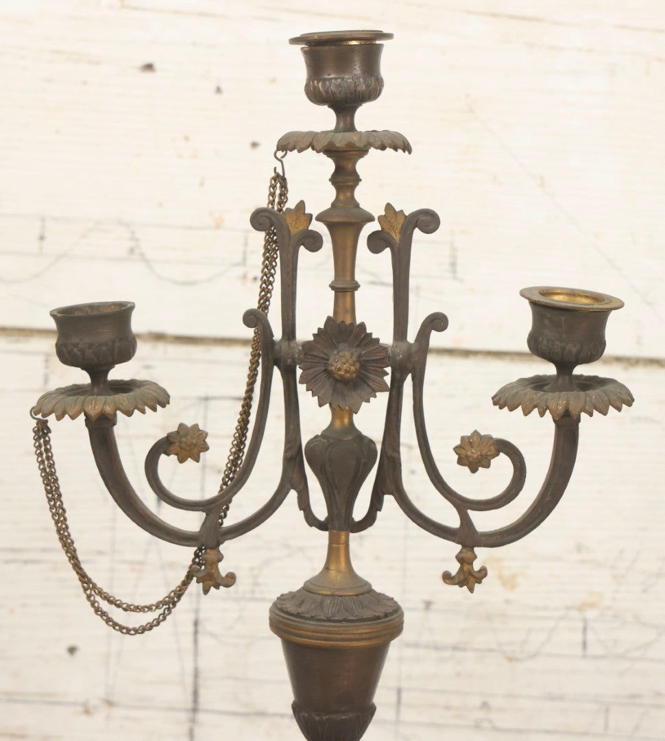 Lot 018 - Pair Of Antique Brass Three-Arm Candelabras With Floral Rosettes, Chains, And Ornate Ornamentation On Black Slate Bases, Circa 1850, 13-1/2" H Each